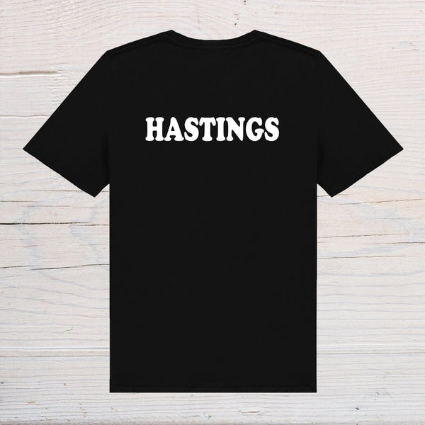 Hastings T-Shirt - black with white text, on front or back, ideal holidays, jokes, tours, gifts, trend setters will wear this! - Rainbowprint.uk