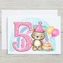Rainbowprintshop birthday card featuring a cute bear with a party hat beside a large pink number 5 and birthday cake